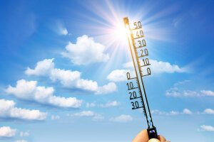 Thermometer in die Sonne gehalten. © PantherMedia_Taut-(YAYMicro)